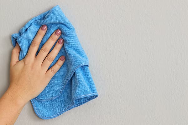 Essuyez le mur peint avec un chiffon en microfibre